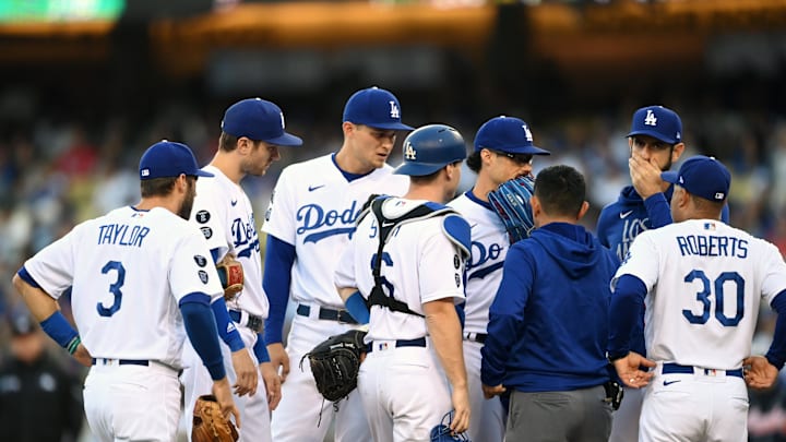 Oct 21, 2021; Los Angeles, California, USA; Los Angeles Dodgers relief pitcher Joe Kelly (17) talks with teammates and manager Dave Roberts (30) on the mound in the first inning against the Atlanta Braves during game five of the 2021 NLCS at Dodger Stadium. 