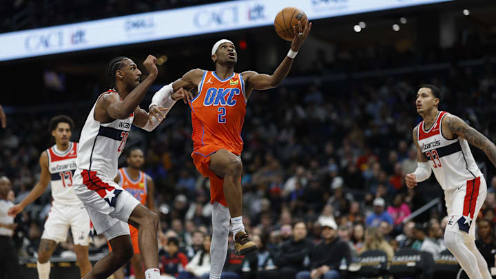 Jan 12, 2025; Washington, District of Columbia, USA; Oklahoma City Thunder guard Shai Gilgeous-Alexander (2) shoots the ball as Washington Wizards forward Alexandre Sarr (20) defends in the third quarter at Capital One Arena. Mandatory Credit: Geoff Burke-Imagn Images