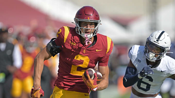 Oct 12, 2024; Los Angeles, California, USA;  USC Trojans wide receiver Duce Robinson (2) runs the ball after a complete pass before he is stopped by Penn State Nittany Lions safety Zakee Wheatley (6) in the second half at United Airlines Field at the Los Angeles Memorial Coliseum. Mandatory Credit: Jayne Kamin-Oncea-Imagn Images