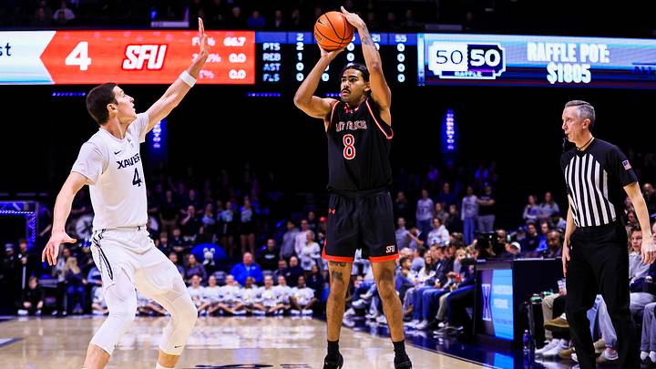 Dec 1, 2025; Cincinnati, Ohio, USA; Saint Francis Red Flash guard Skylar Wicks (8) shoots against Xavier Musketeers forward Filip Borovicanin (4) in the first half at Cintas Center.
