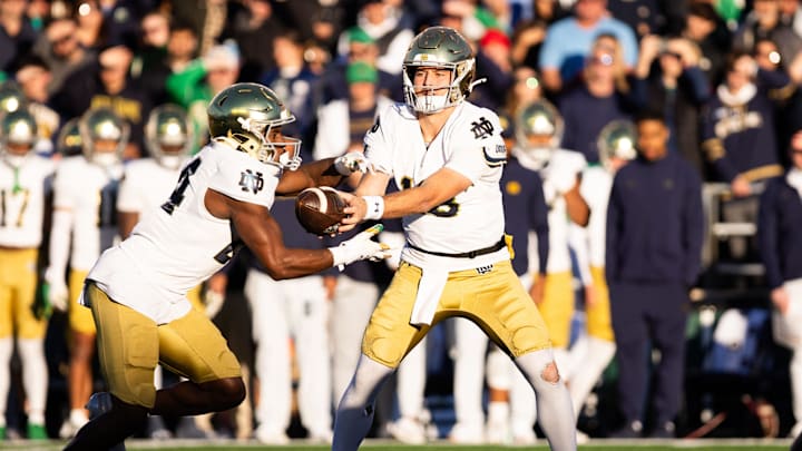 Notre Dame Fighting Irish quarterback CJ Carr (13) gives the ball to running back Jadarian Price (24)
