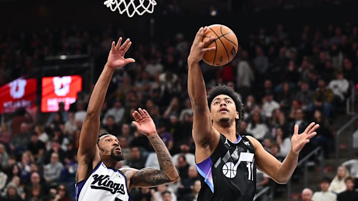 Feb 26, 2025; Salt Lake City, Utah, USA;  Utah Jazz guard Jaden Springer (11) drives past Sacramento Kings guard Malik Monk (0) for a lay up in the second half at Delta Center. Mandatory Credit: Jamie Sabau-Imagn Images