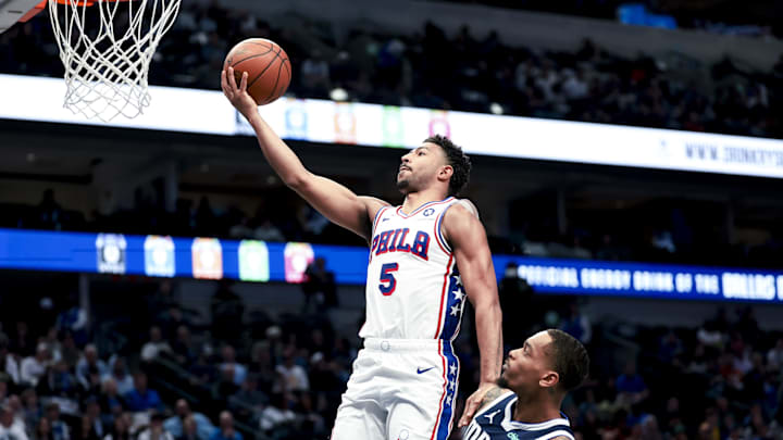 Mar 16, 2025; Dallas, Texas, USA;  Philadelphia 76ers guard Quentin Grimes (5) shoots past Dallas Mavericks forward P.J. Washington (25) during the second half at American Airlines Center. Mandatory Credit: Kevin Jairaj-Imagn Images