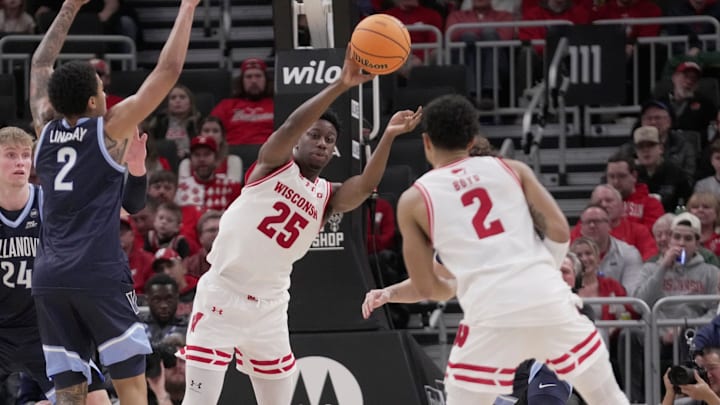 Wisconsin guard John Blackwell (25) passes the ball to guard Nick Boyd (2) during the first half of their game againstVillanova Friday, December 19, 2025 at Fiserv Forum in Milwaukee, Wisconsin.