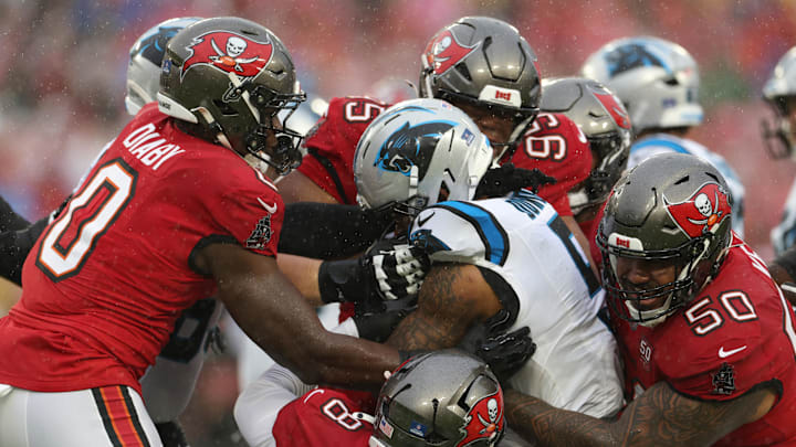 Jan 3, 2026; Tampa, Florida, USA;  Tampa Bay Buccaneers linebacker Sirvocea Dennis (8) and linebacker Yaya Diaby (0) and defensive end Elijah Roberts (95) and defensive tackle Vita Vea (50) tackle Carolina Panthers running back Rico Dowdle (5) in the first half at Raymond James Stadium. Mandatory Credit: Nathan Ray Seebeck-Imagn Images
