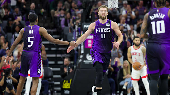 Sacramento Kings forward Domantas Sabonis (11) shakes hands with guard De'Aaron Fox (5). 