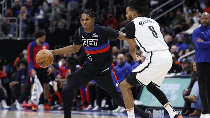 Mar 1, 2025; Detroit, Michigan, USA;  Detroit Pistons forward Ausar Thompson (9) dribbles defended by Brooklyn Nets forward Ziaire Williams (8) in the second half at Little Caesars Arena. Mandatory Credit: Rick Osentoski-Imagn Images