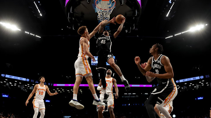 Apr 10, 2025; Brooklyn, New York, USA; Brooklyn Nets guard Keon Johnson (45) drives to the basket against Atlanta Hawks guards Dyson Daniels (5) and Caris LeVert (3) during the third quarter at Barclays Center. Mandatory Credit: Brad Penner-Imagn Images Apr 10, 2025; Brooklyn, New York, USA; Brooklyn Nets guard Keon Johnson (45) drives to the basket against Atlanta Hawks guards Dyson Daniels (5) and Caris LeVert (3) during the third quarter at Barclays Center. Mandatory Credit: Brad Penner-Imagn Images