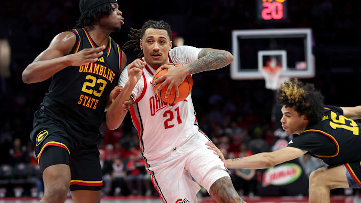 Dec 23, 2025; Columbus, Ohio, USA; Ohio State Buckeyes forward Devin Royal (21) drives to the basket as Grambling State Tigers forward Mekhi Fitts (23) defends during the second half at Value City Arena. Mandatory Credit: Joseph Maiorana-Imagn Images Dec 23, 2025; Columbus, Ohio, USA; Ohio State Buckeyes forward Devin Royal (21) drives to the basket as Grambling State Tigers forward Mekhi Fitts (23) defends during the second half at Value City Arena. Mandatory Credit: Joseph Maiorana-Imagn Images