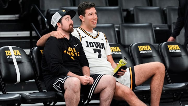 Iowa’s Alvaro Folgueiras (7) sits with a team manager during the Iowa men’s basketball team media day Oct. 15, 2025 at Carver-Hawkeye Arena in Iowa City, Iowa.