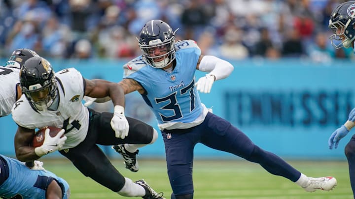 Jacksonville Jaguars running back Tank Bigsby (4) is stopped by Tennessee Titans safety Amani Hooker (37) during the third quarter at Nissan Stadium in Nashville, Tenn., Sunday, Dec. 8, 2024.