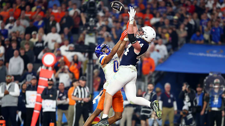 Dec 31, 2024; Glendale, AZ, USA; Penn State Nittany Lions tight end Tyler Warren (44) makes a touchdown catch over Boise State Broncos safety Ty Benefield (0) during the second half in the Fiesta Bowl at State Farm Stadium. Mandatory Credit: Mark J. Rebilas-Imagn Images