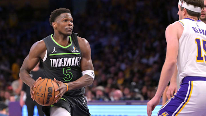 Apr 19, 2025; Los Angeles, California, USA; Minnesota Timberwolves guard Anthony Edwards (5) drives past Los Angeles Lakers guard Austin Reaves (15) in the second half at Crypto.com Arena.