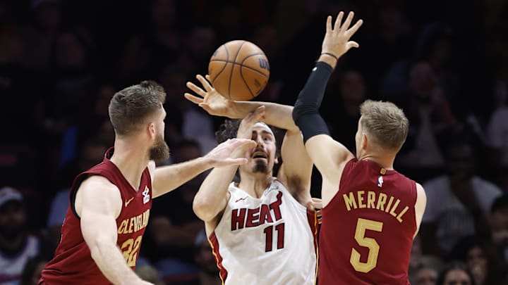 Nov 10, 2025; Miami, Florida, USA;  Cleveland Cavaliers forward Dean Wade (32) and guard Sam Merrill (5) defend Miami Heat forward Jaime Jaquez Jr. (11) during the second half at Kaseya Center. Mandatory Credit: Rhona Wise-Imagn Images
