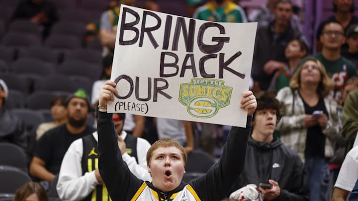 A fan pleads for the SuperSonics to return before a 2023 exhibition game between the Clippers and Jazz in Seattle.