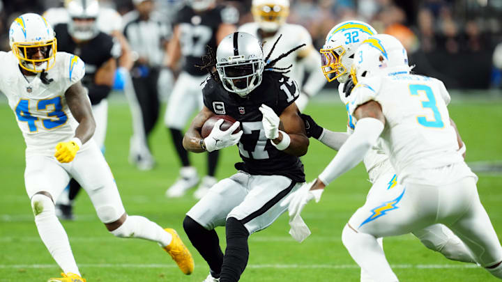 Dec 14, 2023; Paradise, Nevada, USA; Las Vegas Raiders wide receiver Davante Adams (17) runs against Los Angeles Chargers safety Alohi Gilman (32) and safety Derwin James Jr. (3) in the first quarter at Allegiant Stadium. Mandatory Credit: Stephen R. Sylvanie-USA TODAY Sports