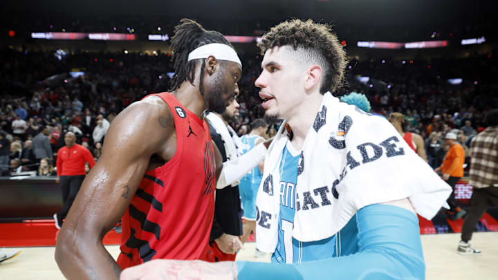 Dec 26, 2022; Portland, Oregon, USA; Portland Trail Blazers small forward Jerami Grant (9, left) embraces Charlotte Hornets point guard LaMelo Ball (1) after a game at Moda Center. Mandatory Credit: Soobum Im-Imagn Images