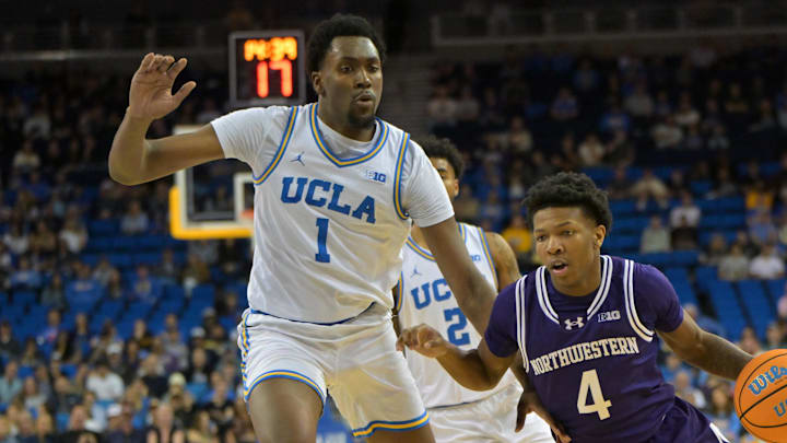 Jan 24, 2026; Los Angeles, California, USA;  UCLA Bruins forward Xavier Booker (1) defends Northwestern Wildcats guard Jayden Reid (4) in the second half at Pauley Pavilion presented by Wescom Financial. Mandatory Credit: Jayne Kamin-Oncea-Imagn Images
