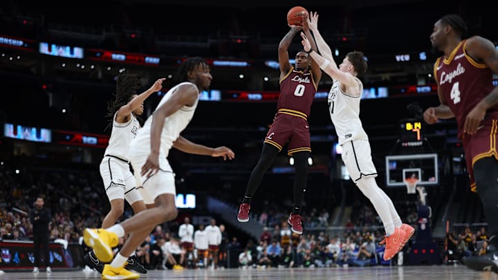 Mar 15, 2025; Washington, D.C., USA; Loyola Chicago Ramblers guard Des Watson (0) shoots the ball as VCU Rams guard Max Shulga (11) defends in the first half at Capital One Arena. Mandatory Credit: Geoff Burke-Imagn Images