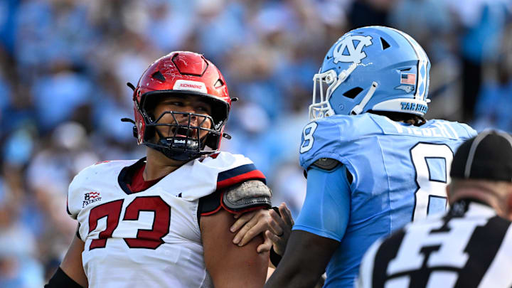 Sep 13, 2025; Chapel Hill, North Carolina, USA; Richmond Spiders offensive lineman Phillip Gray III (73) and North Carolina Tar Heels defensive lineman Smith Vilbert (8) argue in the third quarter at Kenan Stadium. Mandatory Credit: Bob Donnan-Imagn Images