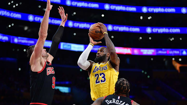 Jan 25, 2024; Los Angeles, California, USA; Los Angeles Lakers forward LeBron James (23) moves to the basket against Chicago Bulls center Nikola Vucevic (9) and forward DeMar DeRozan (11) : Gary A. Vasquez-Imagn Images