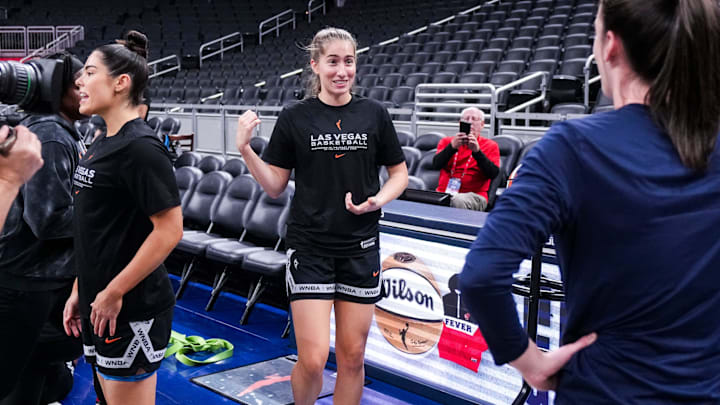 Former Iowa Hawkeyes Las Vegas Aces guard Kate Martin (20) and Indiana Fever guard Caitlin Clark (22) reunite Wednesday, Sept. 11, 2024, during a game between the Indiana Fever and the Las Vegas Aces at Gainbridge Fieldhouse in Indianapolis.