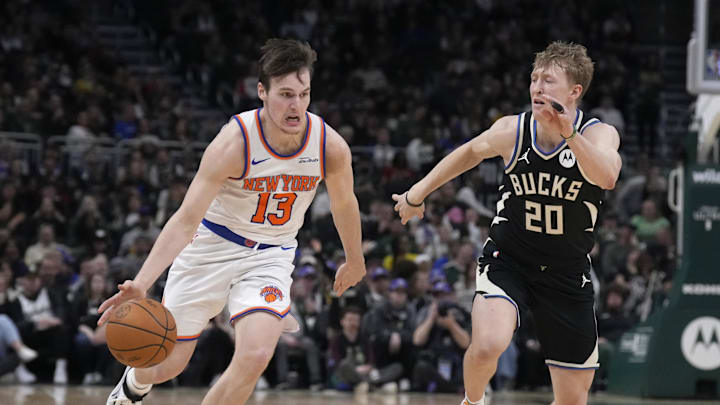 Mar 28, 2025; Milwaukee, Wisconsin, USA; New York Knicks guard Tyler Kolek (13) drives to the basket against Milwaukee Bucks guard AJ Green (20) in the second half  at Fiserv Forum. Mandatory Credit: Michael McLoone-Imagn Images