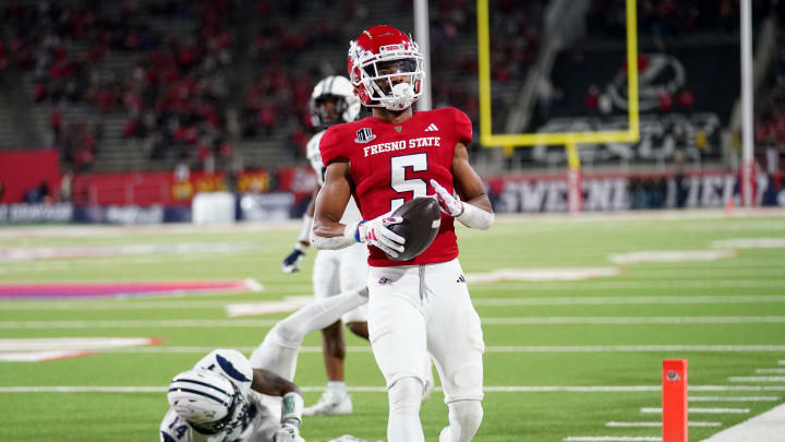 Sep 30, 2023; Fresno, California, USA; Fresno State Bulldogs wide receiver Jaelen Gill (5) scores a touchdown in front of Nevada Wolf Pack defensive back Devin Gunter (14) in the fourth quarter at Valley Children's Stadium. Mandatory Credit: Cary Edmondson-USA TODAY Sports