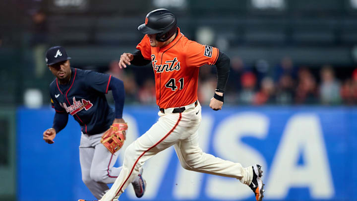 Jun 6, 2025; San Francisco, California, USA; San Francisco Giants first baseman Wilmer Flores (41) runs toward third base against Atlanta Braves second baseman Ozzie Albies (1) during the fifth inning at Oracle Park. Mandatory Credit: Robert Edwards-Imagn Images
