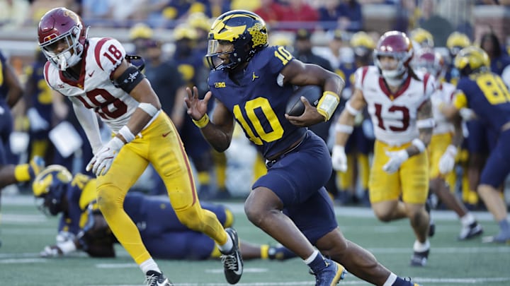 Sep 21, 2024; Ann Arbor, Michigan, USA; Michigan Wolverines quarterback Alex Orji (10) runs in the second half against the USC Trojans at Michigan Stadium. Mandatory Credit: Rick Osentoski-Imagn Images Sep 21, 2024; Ann Arbor, Michigan, USA; Michigan Wolverines quarterback Alex Orji (10) runs in the second half against the USC Trojans at Michigan Stadium. Mandatory Credit: Rick Osentoski-Imagn Images