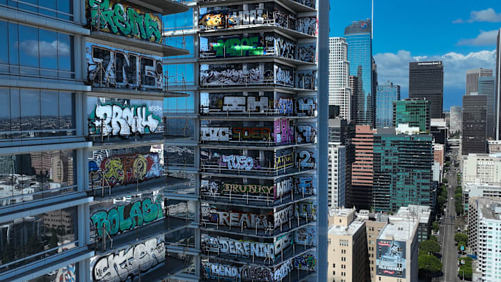The abandoned Oceanwide Plaza looms over downtown Los Angeles, its graffiti-splashed facade marking a project frozen in time.