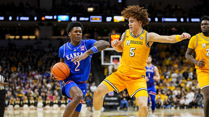 Dec 8, 2024; Columbia, Missouri, USA; Kansas Jayhawks guard AJ Storr (2) drives against Missouri Tigers guard T.O. Barrett (5) during the second half at Mizzou Arena. Mandatory Credit: Jay Biggerstaff-Imagn Images