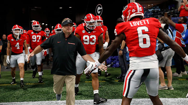 Georgia coach Kirby Smart leads his team onto the field for warm ups before the start of the NCAA Aflac Kickoff Game in Atlanta, on Saturday, Aug. 31, 2024.