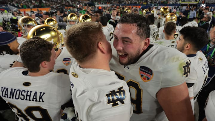 Jan 9, 2025; Miami, FL, USA; Notre Dame Fighting Irish offensive lineman Tosh Baker (79) celebrates with offensive lineman Sam Pendleton (72) after defeating the Penn State Nittany Lions  in the Orange Bowl at Hard Rock Stadium. Mandatory Credit: Sam Navarro-Imagn Images
