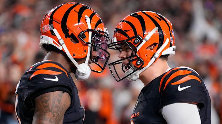 Cincinnati Bengals wide receiver Tee Higgins (5) and quarterback Joe Burrow (9) celebrate a touchdown in the fourth quarter of the NFL Week 17 game between the Cincinnati Bengals and the Denver Broncos at Paycor Stadium in downtown Cincinnati on Saturday, Dec. 28, 2024. The Bengals took a 30-24 win in overtime to remain in the post season chase.