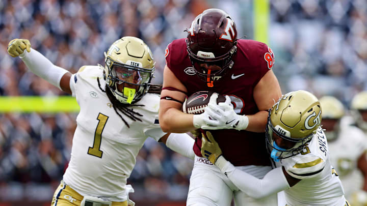 Oct 26, 2024; Blacksburg, Virginia, USA; Virginia Tech Hokies tight end Benji Gosnell (82) is tackled by Georgia Tech Yellow Jackets defensive back Rodney Shelley (6) and defensive back LaMiles Brooks (1) during the second quarter at Lane Stadium. Mandatory Credit: Peter Casey-Imagn Images
