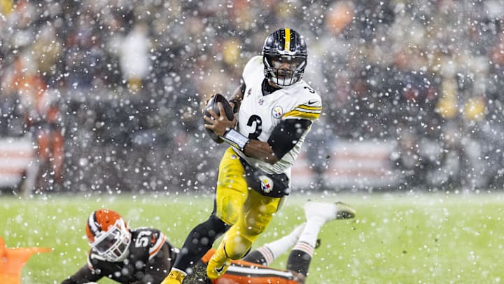Nov 21, 2024; Cleveland, Ohio, USA; Pittsburgh Steelers quarterback Russell Wilson (3) runs the ball past Cleveland Browns defensive end Isaiah McGuire (57) for a first down during the third quarter at Huntington Bank Field Stadium. Mandatory Credit: Scott Galvin-Imagn Images