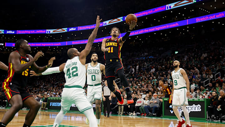 Nov 26, 2023; Boston, Massachusetts, USA; Atlanta Hawks guard Trae Young (11) goes to the basket against Boston Celtics center Al Horford (42) during the first quarter at TD Garden. Mandatory Credit: Winslow Townson-Imagn Images