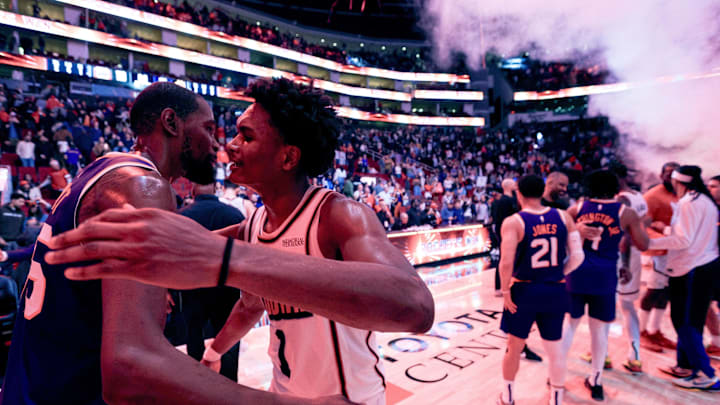 Feb 12, 2025; Houston, Texas, USA; Phoenix Suns forward Kevin Durant (35) hugs Houston Rockets forward Amen Thompson (1) after a game at Toyota Center. Mandatory Credit: Thomas Shea-Imagn Images