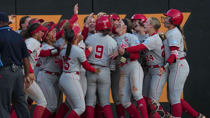 Nebraska's Hannah Camenzind (9) celebrates with teammates after hitting a home run during a NCAA super regional game between Tennessee and Nebraska at Sherri Parker Lee Stadium in Knoxville, Tenn., on May 23, 2025.