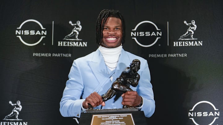 Dec 14, 2024; New York, NY, USA; Colorado Buffaloes wide receiver/cornerback Travis Hunter poses for a photo after winning the Heisman Trophy award during the 2024 Heisman Trophy Presentation. Mandatory Credit: Lucas Boland-Imagn Images