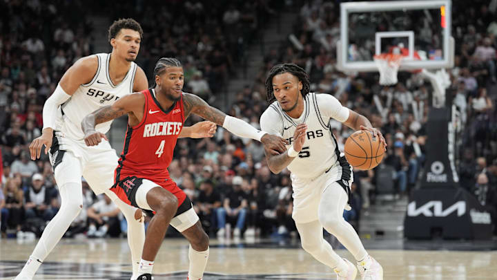 Oct 26, 2024; San Antonio, Texas, USA;  San Antonio Spurs guard Stephon Castle (5) dribbles past Houston Rockets guard Jalen Green (4) in the second half at Frost Bank Center. Mandatory Credit: Daniel Dunn-Imagn Images
