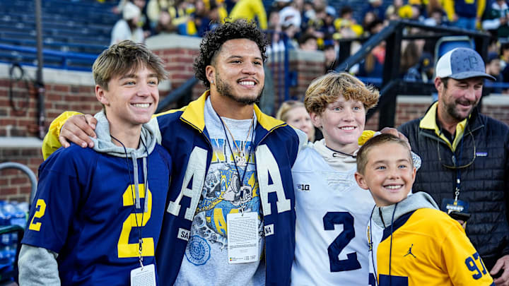 Former Michigan running back Blake Corum takes photos with fans on the sideline before the Michigan State game at Michigan Stadium in Ann Arbor on Saturday, Oct. 26, 2024. Former Michigan running back Blake Corum takes photos with fans on the sideline before the Michigan State game at Michigan Stadium in Ann Arbor on Saturday, Oct. 26, 2024.
