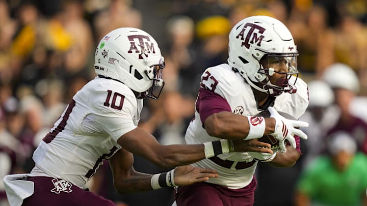 Nov 8, 2025; Columbia, Missouri, USA; Texas A&M Aggies running back Jamarion Morrow (23) takes the handoff from quarterback Marcel Reed (10) during the first half against the Missouri Tigers at Faurot Field at Memorial Stadium. Mandatory Credit: Jay Biggerstaff-Imagn Images