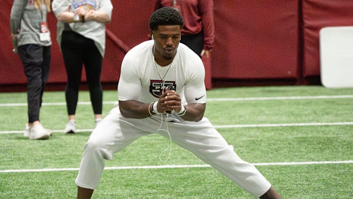 March 25, 2026; Tuscaloosa, AL, USA; Wide receiver Germie Bernard stretches during Pro Day in the Hank Crisp Indoor Practice Facility at the University of Alabama.