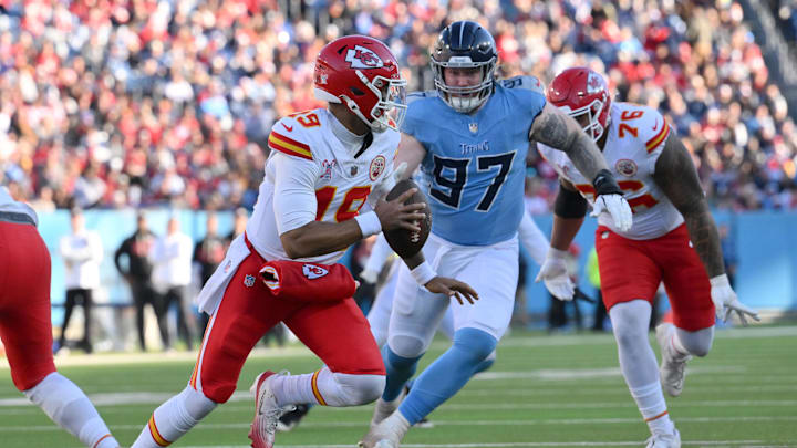 Dec 21, 2025; Nashville, Tennessee, USA; Kansas City Chiefs quarterback Chris Oladokun (19) scrambles against Tennessee Titans defensive tackle James Lynch (97) during the second half at Nissan Stadium. Mandatory Credit: Steve Roberts-Imagn Images