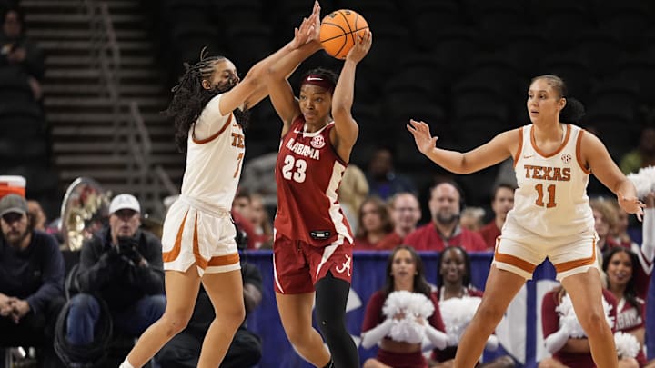 Mar 6, 2026; Greenville, SC, USA; Alabama Crimson Tide guard Jessica Timmons (23) passes the ball pressured by Texas Longhorns guard Jordan Lee (7) during the second half at Bon Secours Wellness Arena. Mandatory Credit: Jim Dedmon-Imagn Images