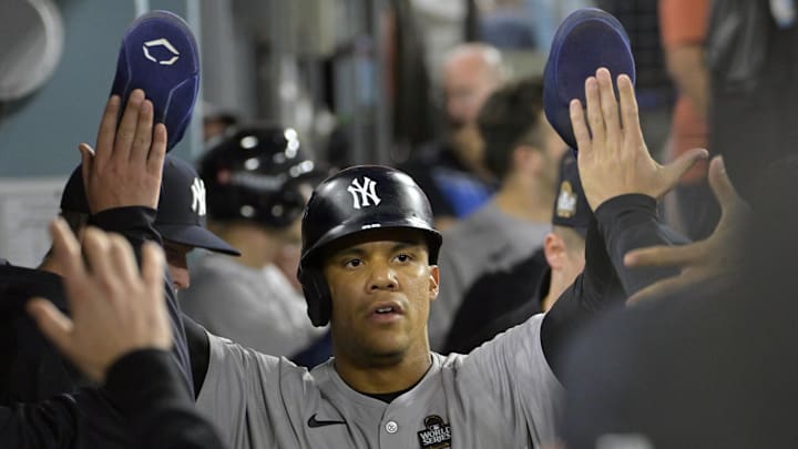 Oct 26, 2024; Los Angeles, California, USA; New York Yankees outfielder Juan Soto (22) celebrates in the dugout after scoring on an RBI single by designated hitter Giancarlo Stanton (not pictured) in the ninth inning against the Los Angeles Dodgers during game two of the 2024 MLB World Series at Dodger Stadium. Mandatory Credit: Jayne Kamin-Oncea-Imagn Images