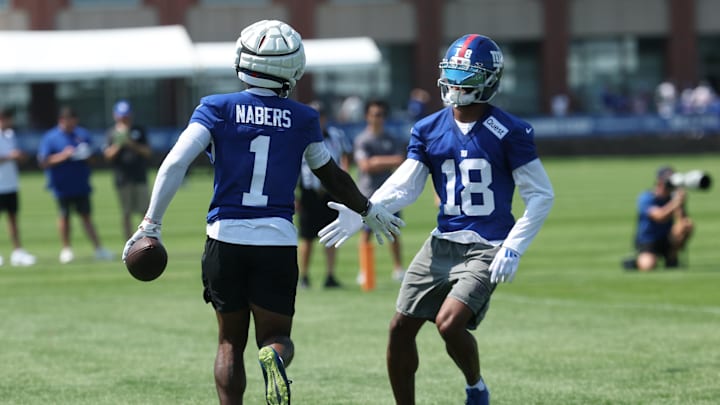 Jul 24, 2025; East Rutherford, NJ, USA; New York Giants wide receiver Malik Nabers (1) and New York Giants wide receiver Darius Slayton (18) celebrate during training camp at Quest Diagnostics Training Center. Mandatory Credit: Vincent Carchietta-Imagn Images
