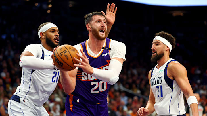Dec 27, 2024; Phoenix, Arizona, USA; Phoenix Suns center Jusuf Nurkic (20) passes the ball against Dallas Mavericks center Daniel Gafford (21) and guard Klay Thompson (31) during the second quarter at Footprint Center. Mandatory Credit: Mark J. Rebilas-Imagn Images